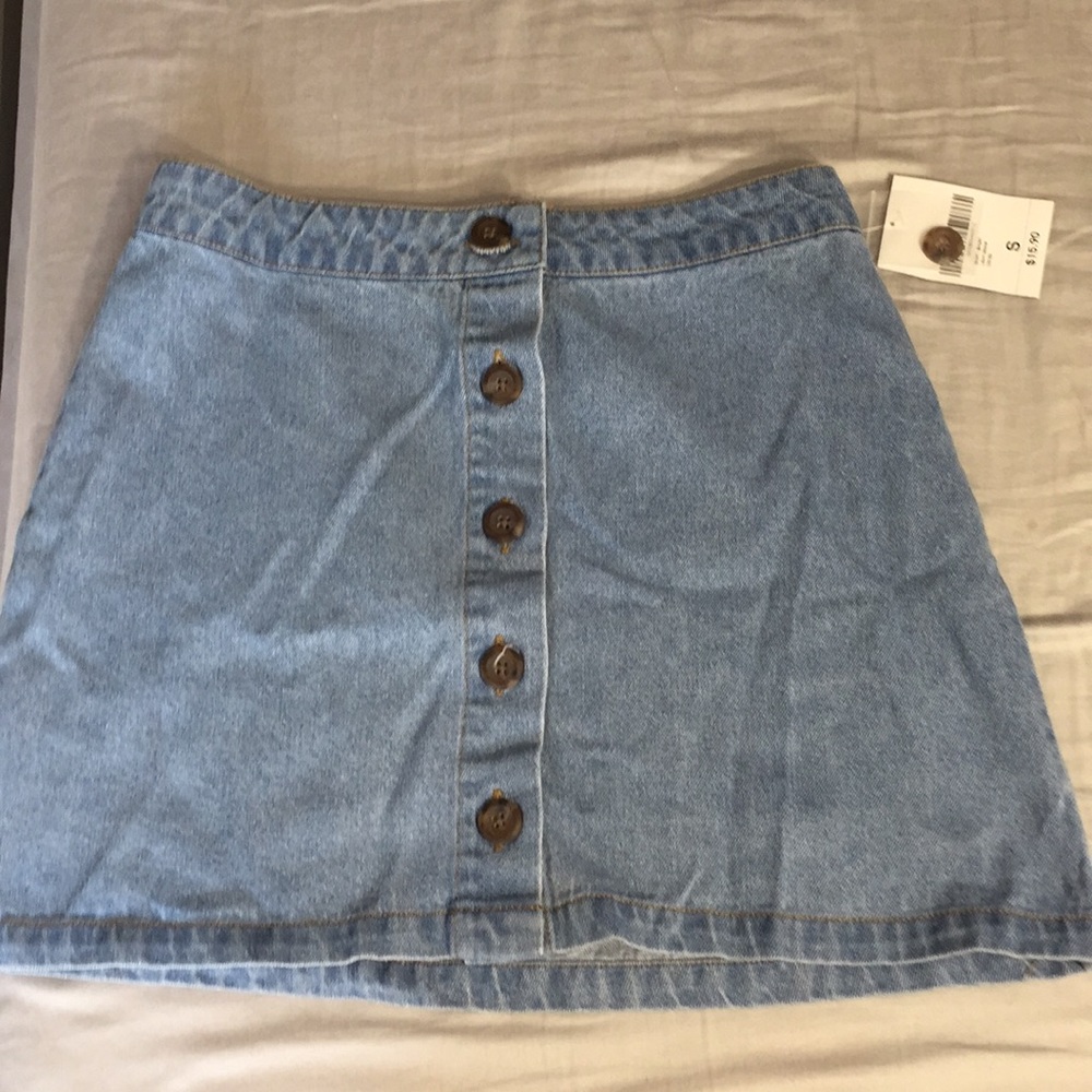 I am selling a denim skirt with brown buttons.